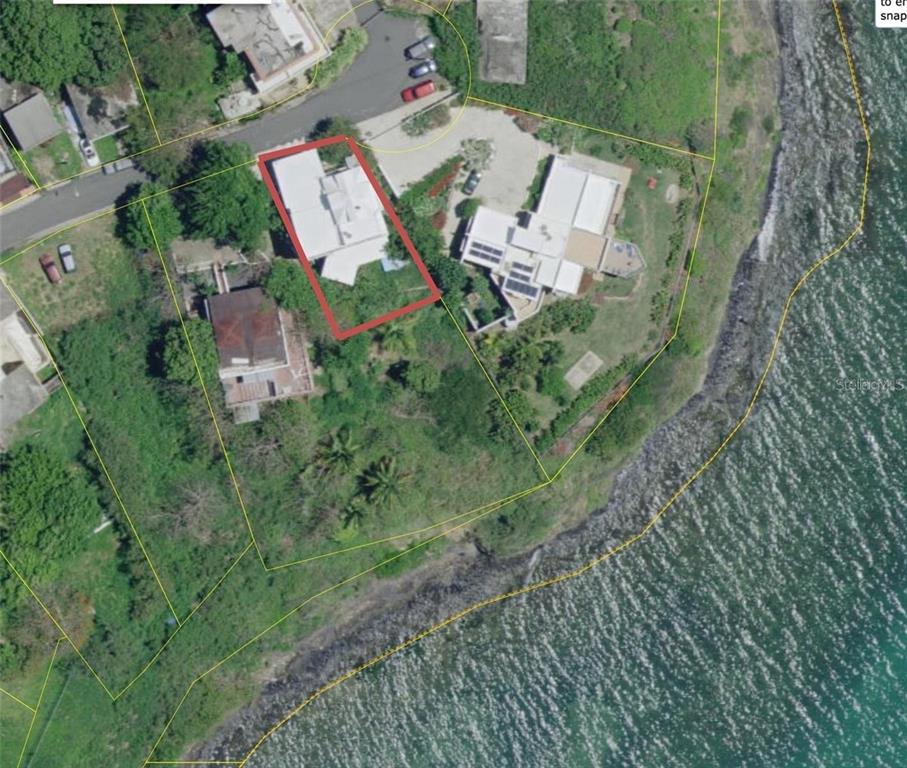 An aerial view shows a residential property with a highlighted house near the coastline — 111 FIDENCIO DE JESUS, FAJARDO, PR