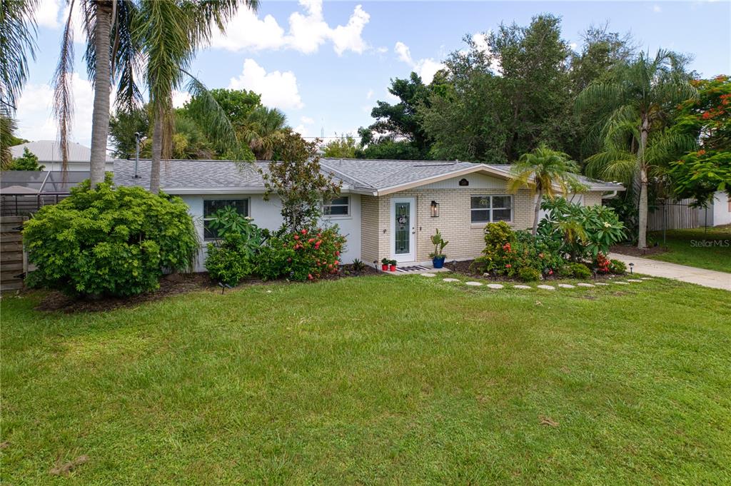 A single-story brick house with a gray shingled roof and a front lawn — 510 DONA DRIVE, NOKOMIS, FL