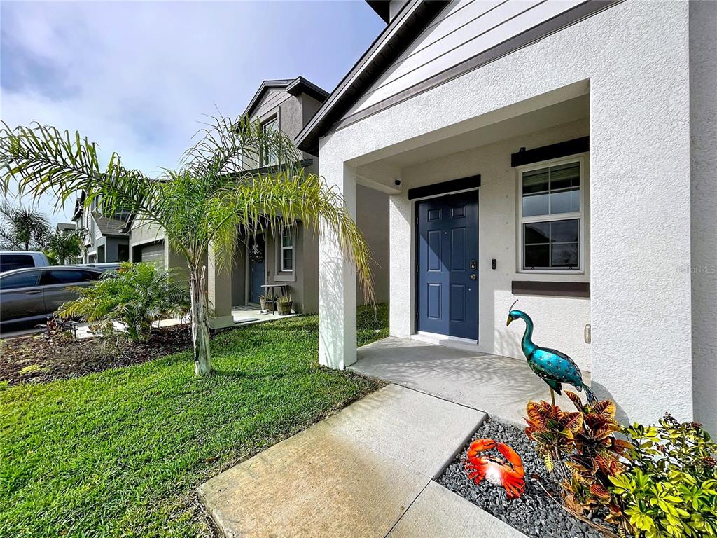 A two-story suburban house with a white exterior, dark trim, and a two-car garage — 3141 OYSTER COVE STREET, WIMAUMA, FL