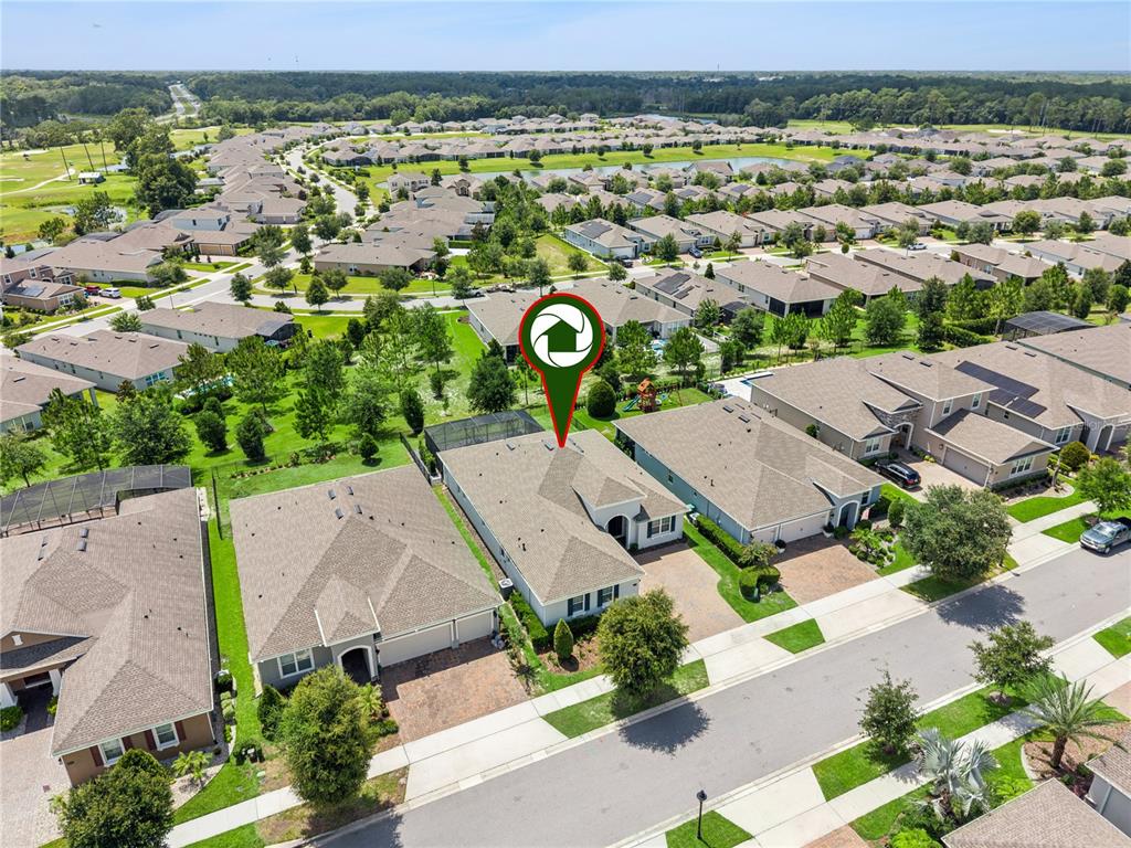 An aerial view shows a suburban neighborhood with single-family homes and a marked property — 464 WEDGEWORTH LANE, DELAND, FL