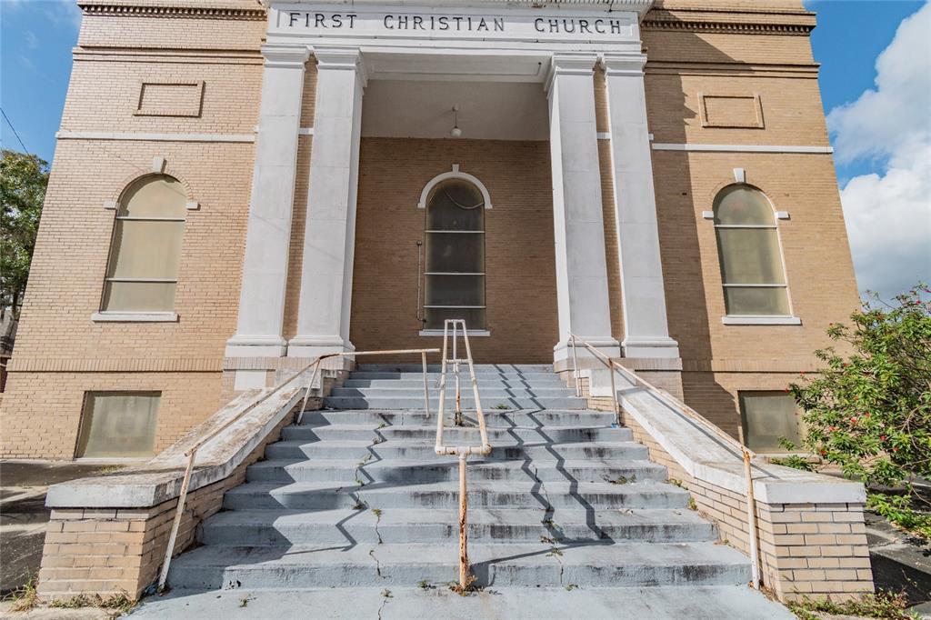 The exterior of a brick church building features a large staircase leading to a columned entrance — 541 S FLORIDA AVENUE, LAKELAND, FL