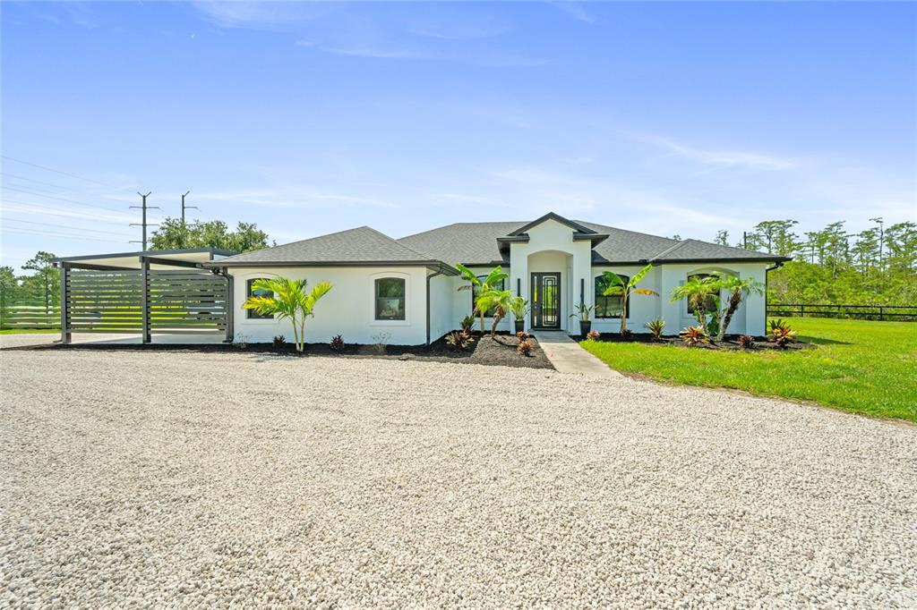 An aerial view of a white house with a pool, patio, and detached gazebo — 20802 PADDOCK STREET, ORLANDO, FL