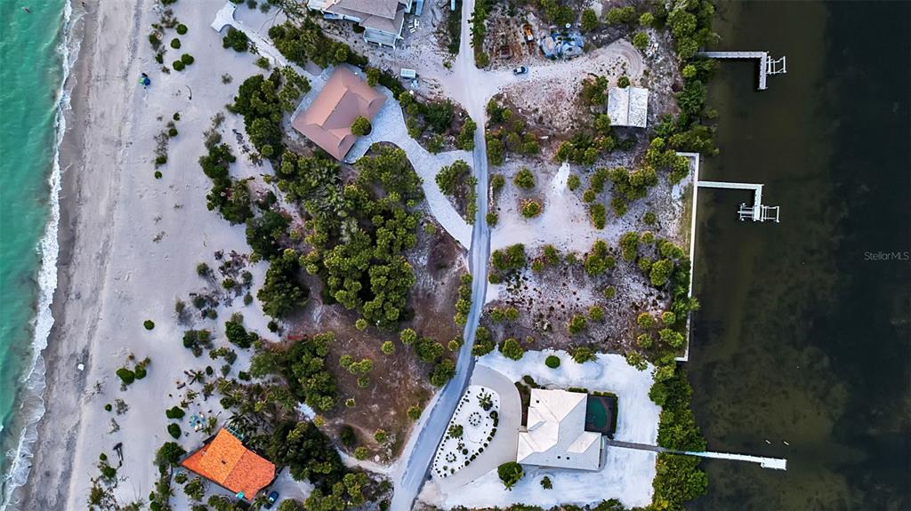 An aerial view shows coastal homes situated between a sandy beach and a bay — N MANASOTA KEY ROAD, ENGLEWOOD, FL