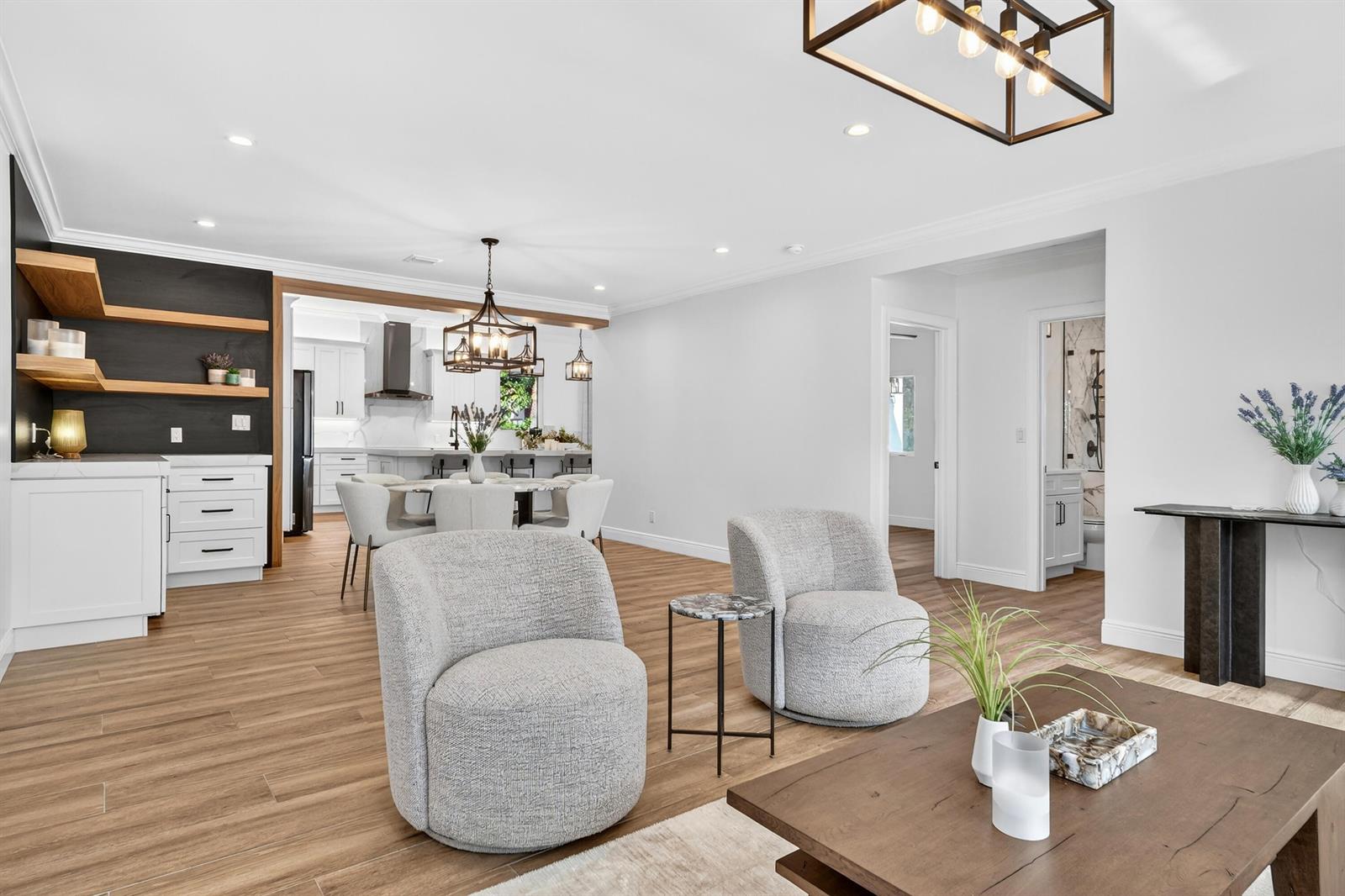 A bright living area features two gray armchairs, a coffee table, and an open kitchen — 301 Pilgrim Road, West Palm Beach FL 33405, WEST PALM BEACH, FL