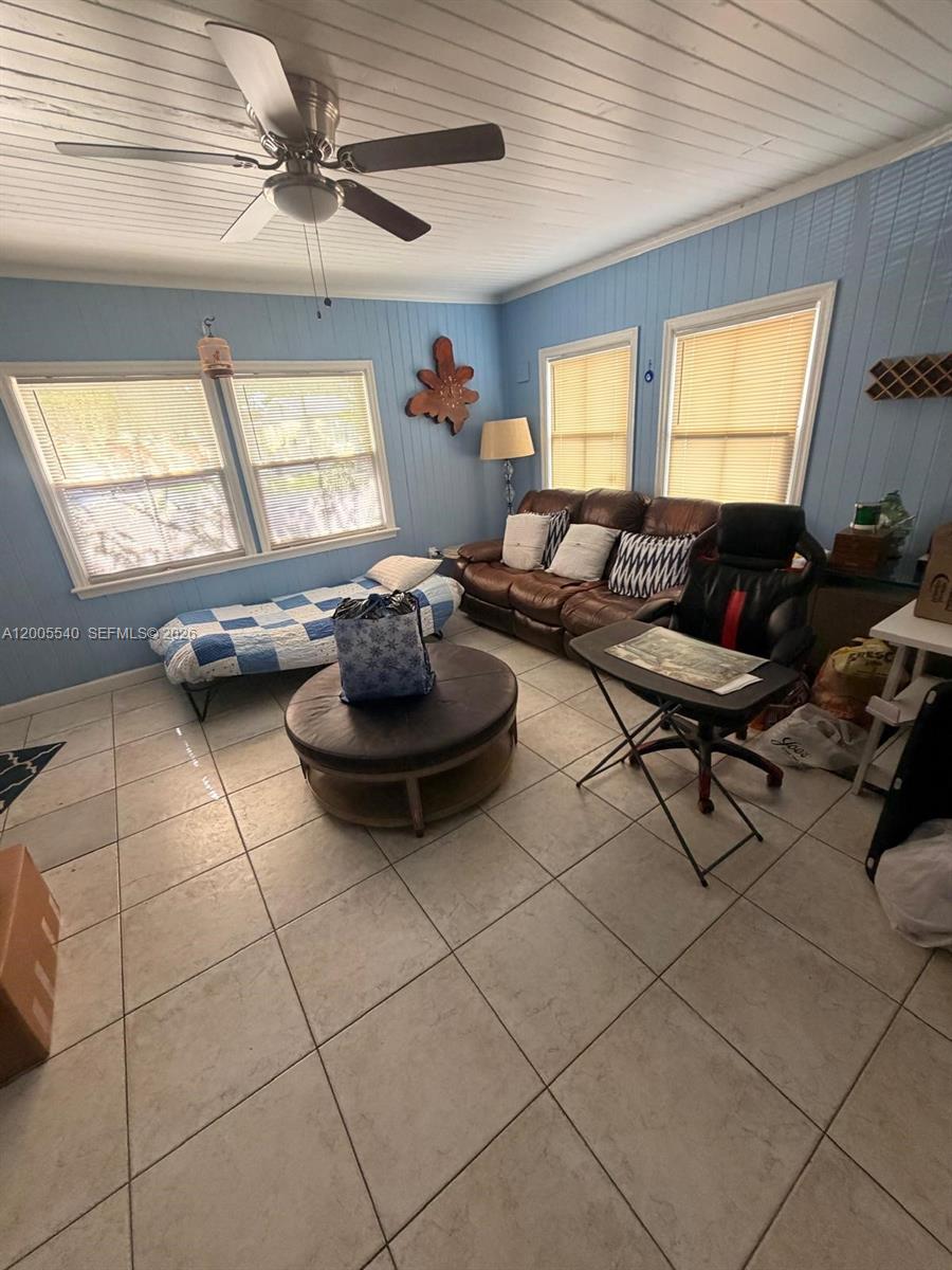 A living room features light blue paneled walls, tile flooring, and a brown leather sofa — 2835 SW 37th Ct # 1, Miami FL 33134, MIAMI, FL