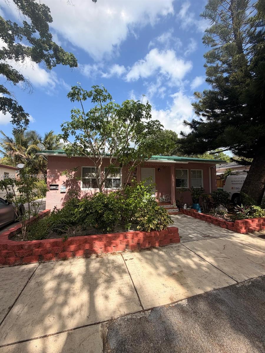 A pink single-story house features a red brick planter and a paved walkway — 2835 SW 37th Ct # 1, Miami FL 33134, MIAMI, FL