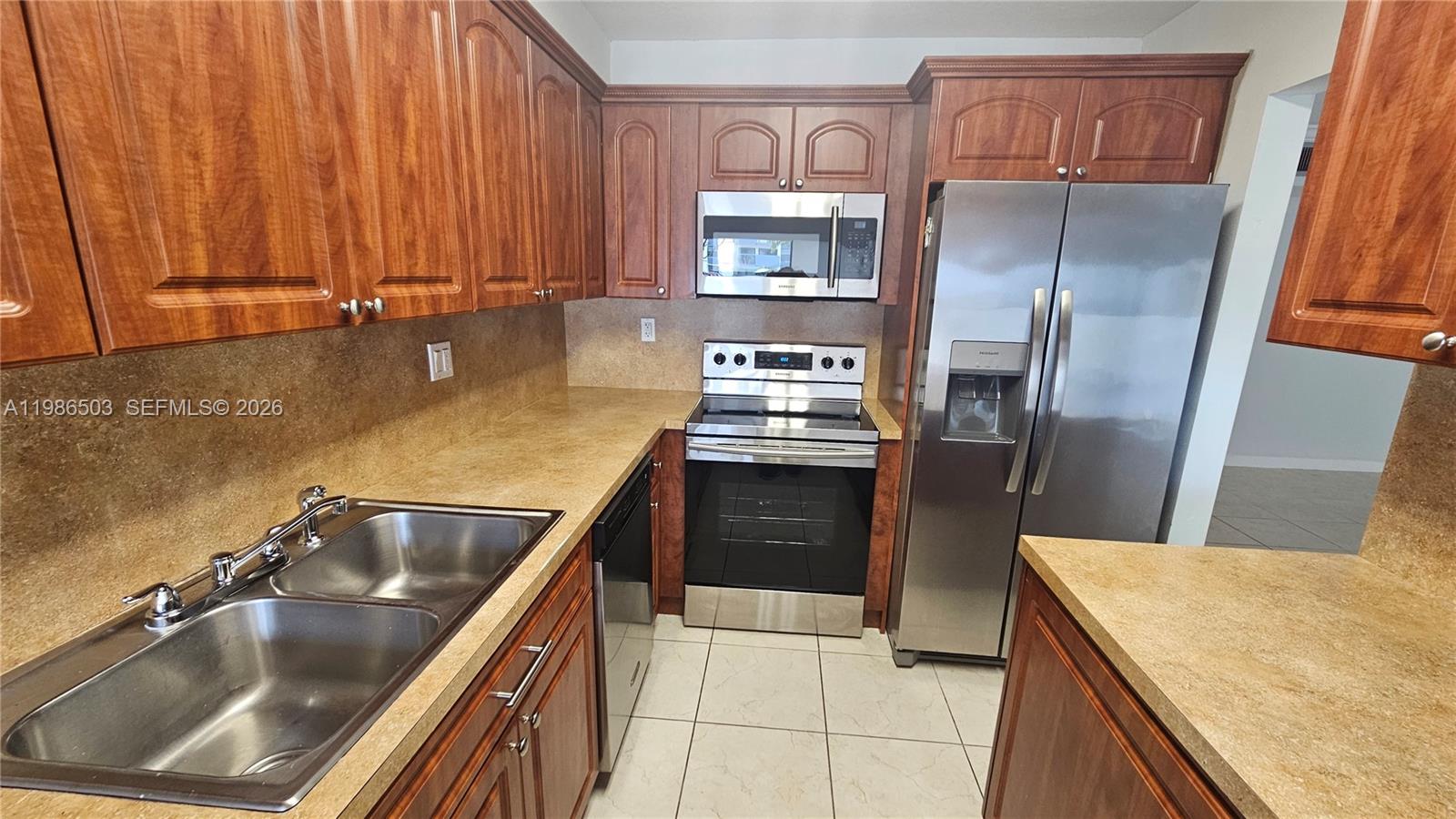 A tiled patio sits outside a sliding glass door next to a parking lot — 5800 SW 127th Ave # 2109, Miami FL 33183, MIAMI, FL