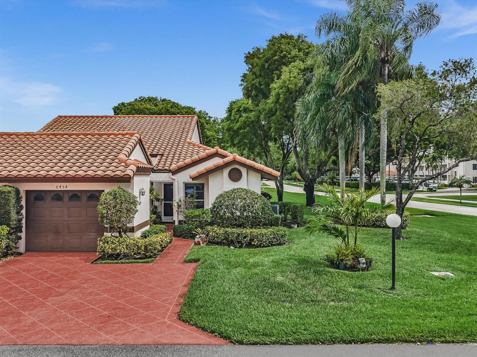 A one-story house with a terracotta tile roof, brown garage door, and red driveway — 6454 Pointe Pleasant Circle, Delray Beach FL 33484, DELRAY BEACH, FL