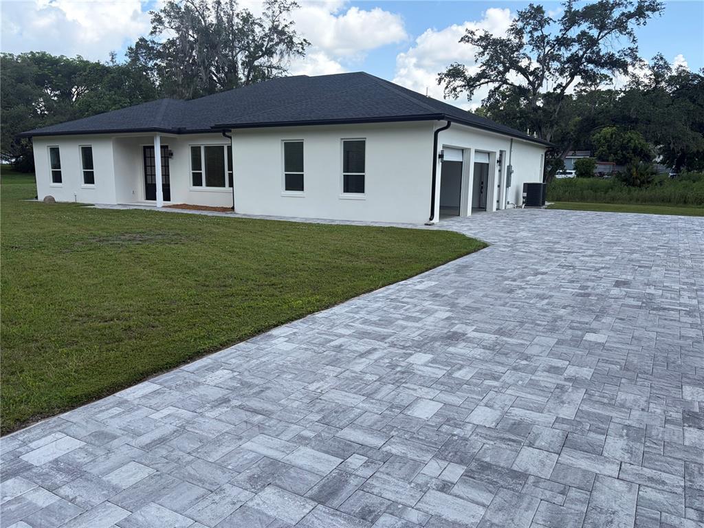 A white house with a dark roof and a large paver driveway — 1148 TURNER LANE, ALTAMONTE SPRINGS, FL
