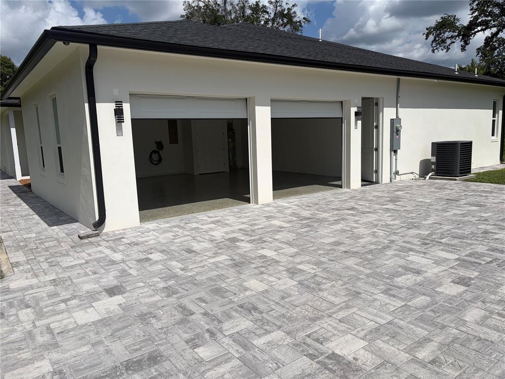 A two-car garage with a paver driveway and a white stucco exterior — 1148 TURNER LANE, ALTAMONTE SPRINGS, FL