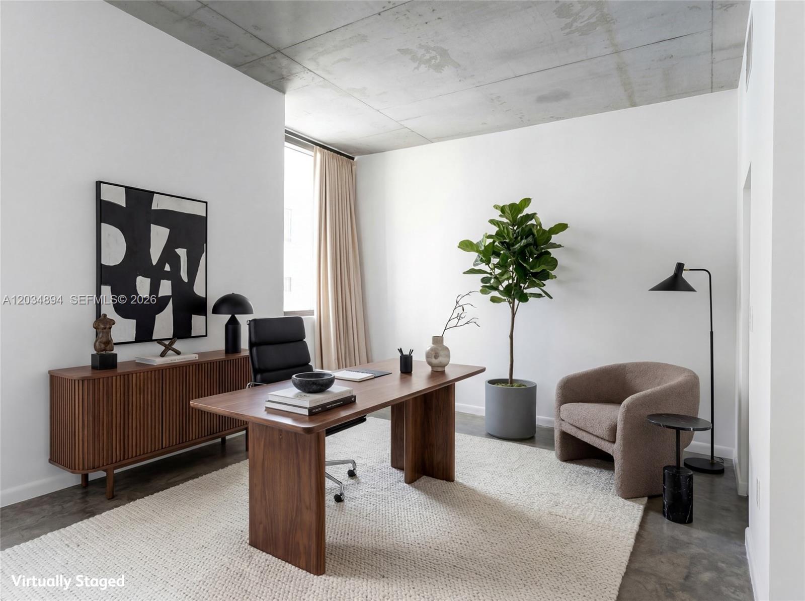 A modern home office features a wooden desk, a textured rug, and a concrete ceiling — 133 NE 2nd Ave # 801, Miami FL 33132, MIAMI, FL