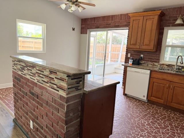 A kitchen features a brick-faced breakfast bar, wood cabinets, and a tiled floor — 1092 EASTBROOK BOULEVARD, WINTER PARK, FL