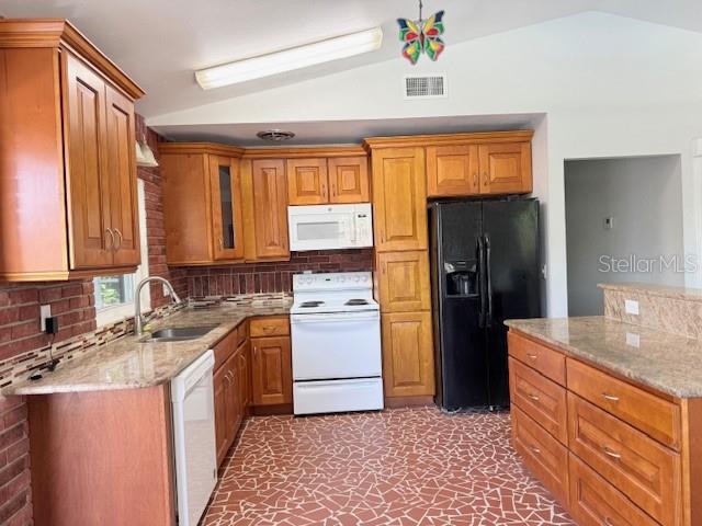 A kitchen features wood cabinets, granite countertops, a white stove, and a black refrigerator — 1092 EASTBROOK BOULEVARD, WINTER PARK, FL