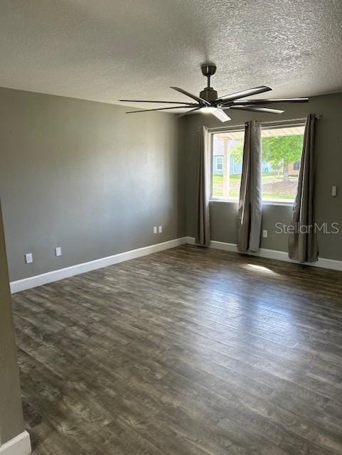 An empty room features gray walls, wood-look flooring, a ceiling fan, and a window with curtains — 1135 SIBONEY STREET NW, PALM BAY, FL