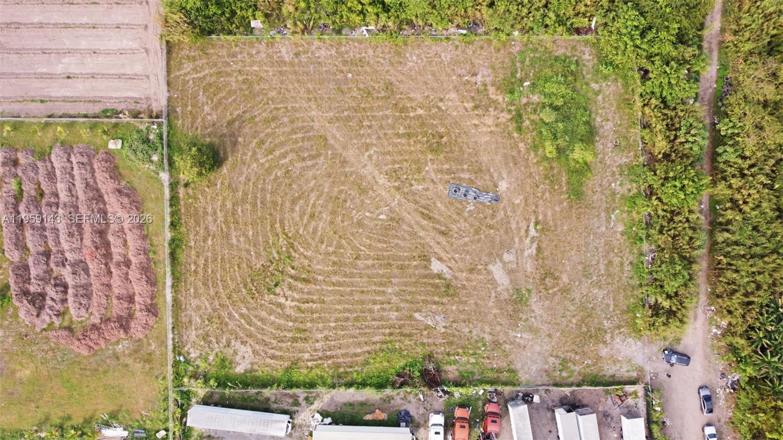 An aerial view shows a large, rectangular, fenced-in vacant lot with sparse vegetation — 160XX SW 207TH AVE, Miami FL 33187, MIAMI, FL