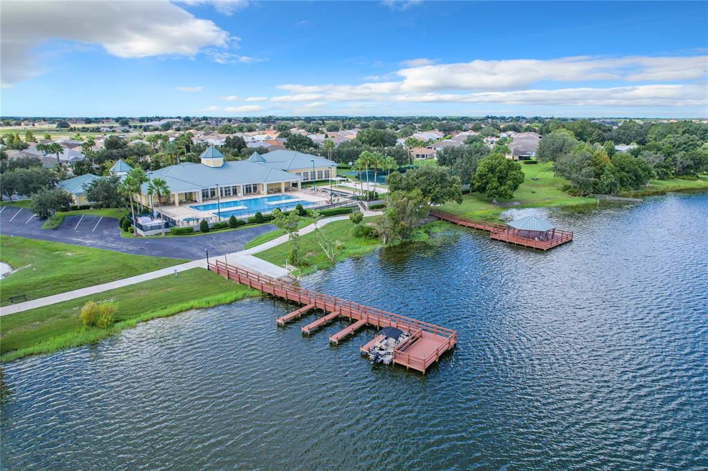 An aerial view shows a community clubhouse with a pool, a dock, and a gazebo — 4019 CARTERET DRIVE, WINTER HAVEN, FL