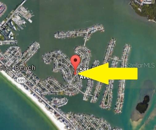This is a satellite map showing a residential neighborhood with a red location pin — 586 140TH AVENUE E UNIT 2, MADEIRA BEACH, FL