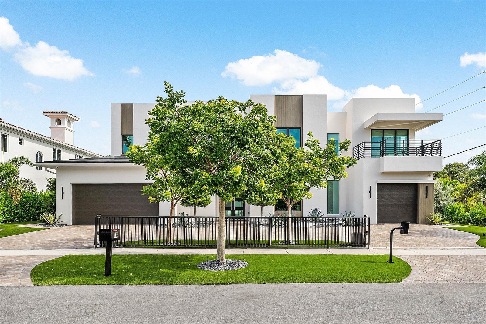 A modern two-story white house with two garages, a front fence, and a large tree — 499 NE 4th Street, Boca Raton FL 33432, BOCA RATON, FL