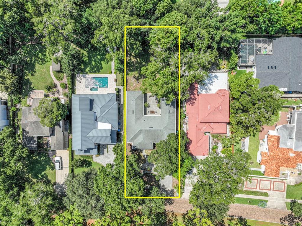 An aerial view shows a house with a central courtyard surrounded by trees and landscaping — 150 E READING WAY, WINTER PARK, FL