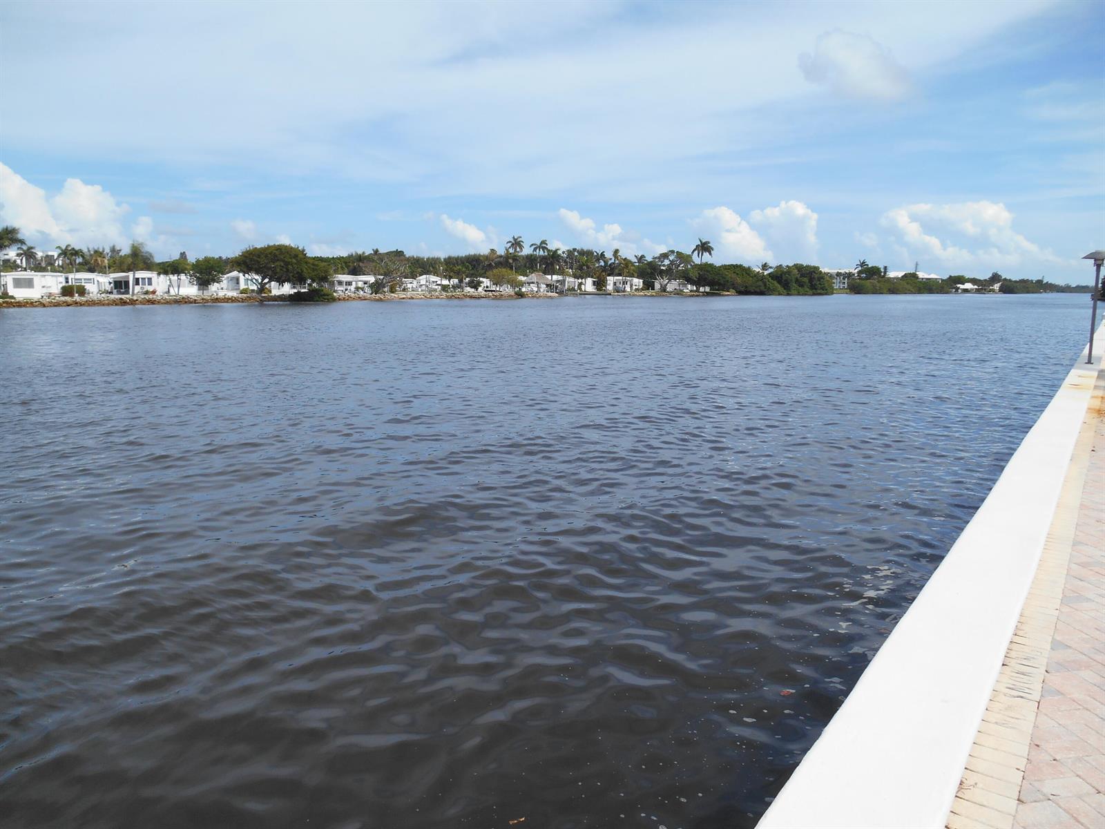 A view of a calm river with a residential community on the opposite bank — 2016 S Federal Highway # 204, Boynton Beach FL 33435, BOYNTON BEACH, FL