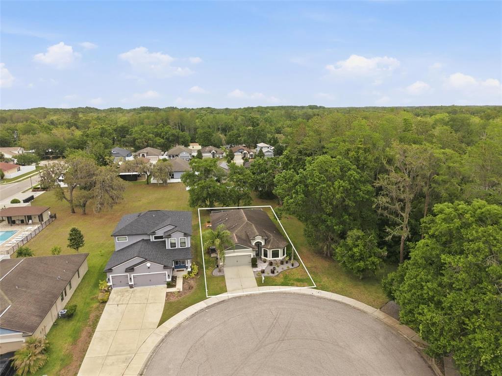 An aerial view shows a single-story house with a driveway located on a cul-de-sac — 12417 CORALBEAN COURT, NEW PORT RICHEY, FL