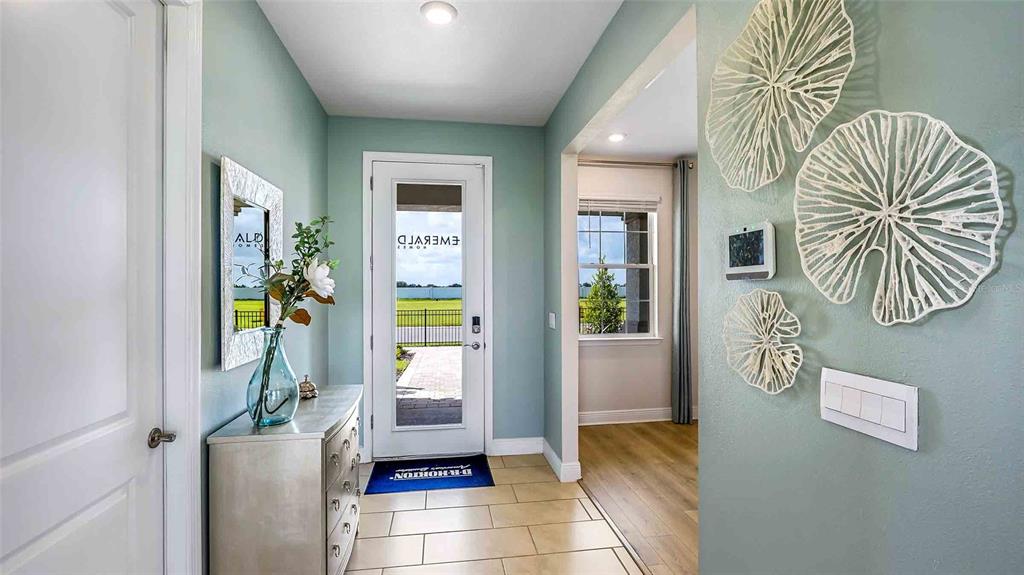 A modern kitchen features white cabinetry, stainless steel appliances, a center island, and wood flooring — 4306 SILVER BIRCH COURT, PALMETTO, FL