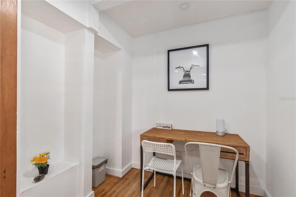 A small home office area features a wooden desk, two chairs, and a framed print — 510 SE 19TH STREET, OCALA, FL