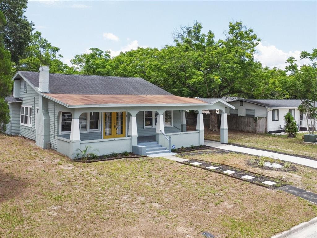 A light green house with a large front porch and yellow double doors — 724 EUCLID AVENUE, LAKE WALES, FL