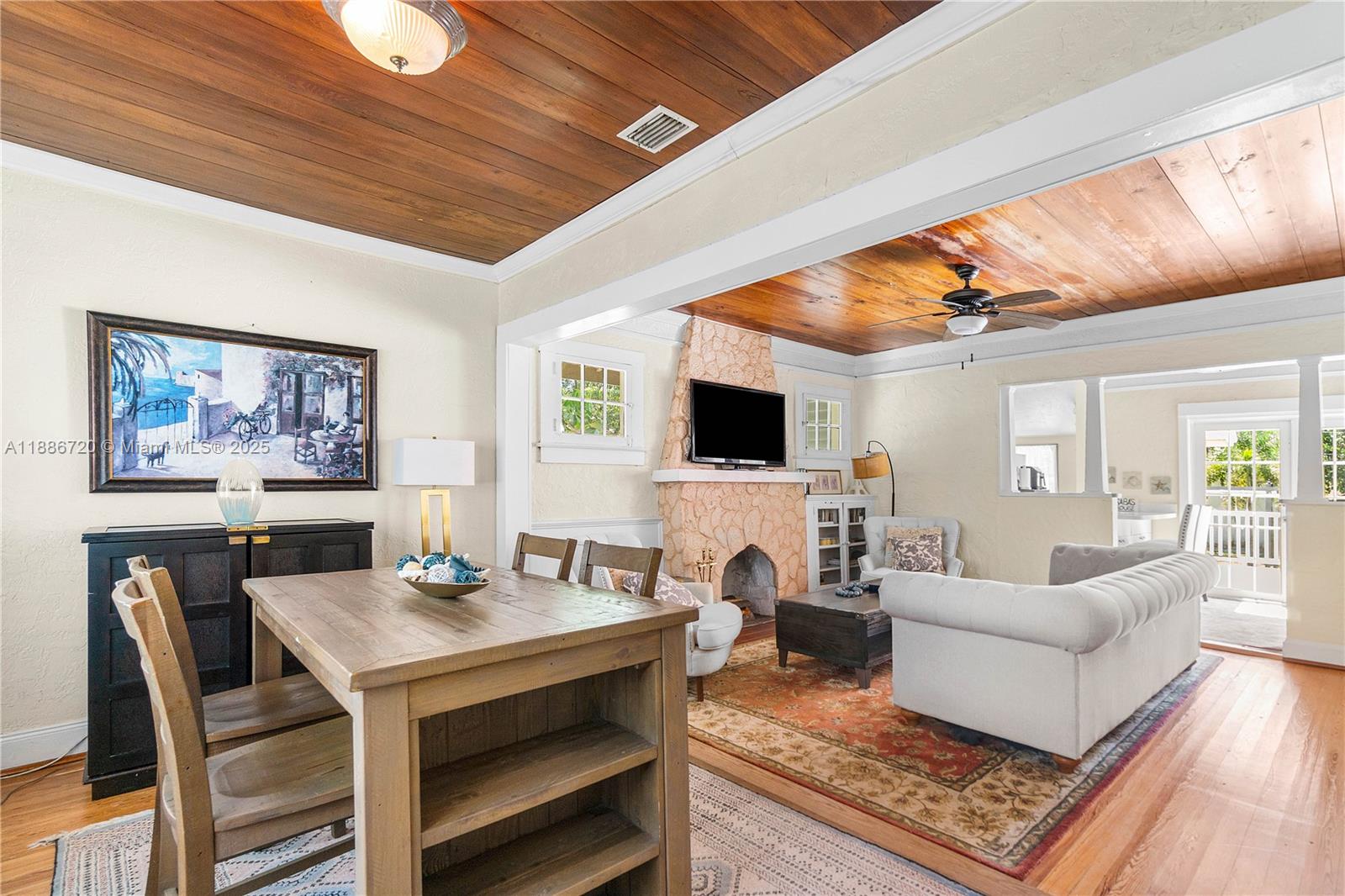 A living and dining area features wood-plank ceilings, a stone fireplace, and hardwood floors — 728 Newark St, West Palm Beach FL 33401, WEST PALM BEACH, FL