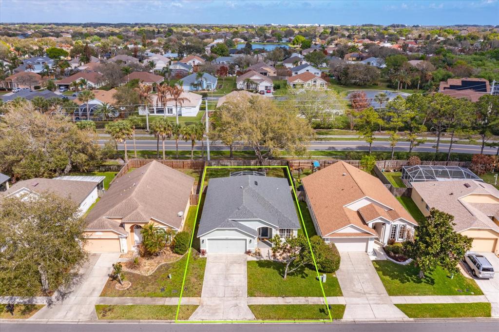 An aerial view shows a single-story house with a gray roof and a green-outlined yard — 2532 VENTURA CIRCLE, WEST MELBOURNE, FL