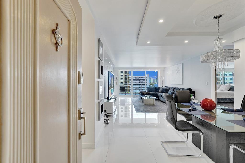 A view from an entryway into a modern living and dining area with white floors — 2030 S Ocean Drive # 510, Hallandale Beach FL 33009, HALLANDALE BEACH, FL