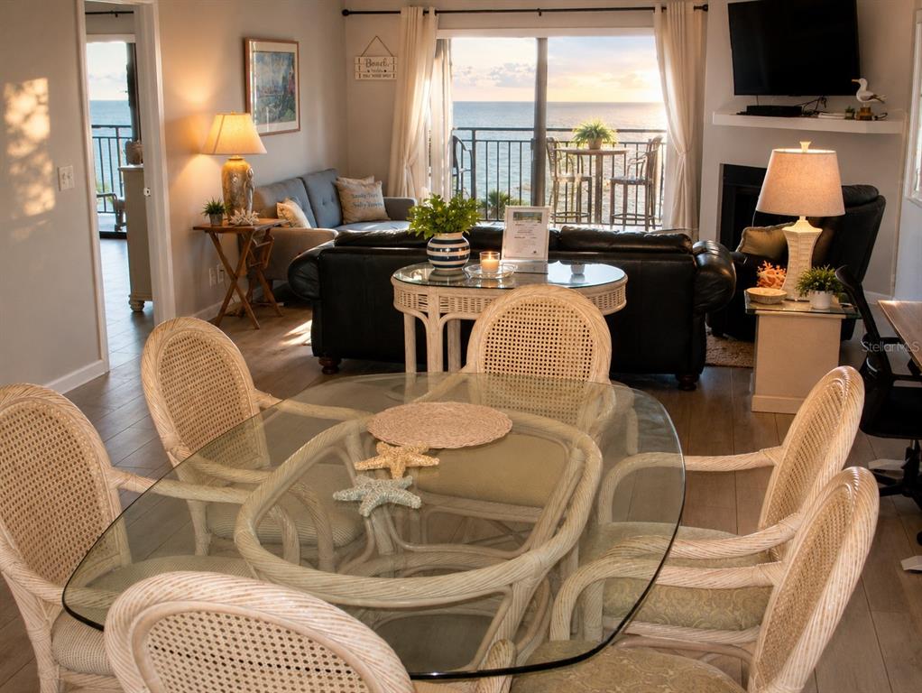 A kitchen features white cabinets, granite countertops, stainless steel appliances, and a central island — 9825 HARRELL AVENUE UNIT 404, TREASURE ISLAND, FL