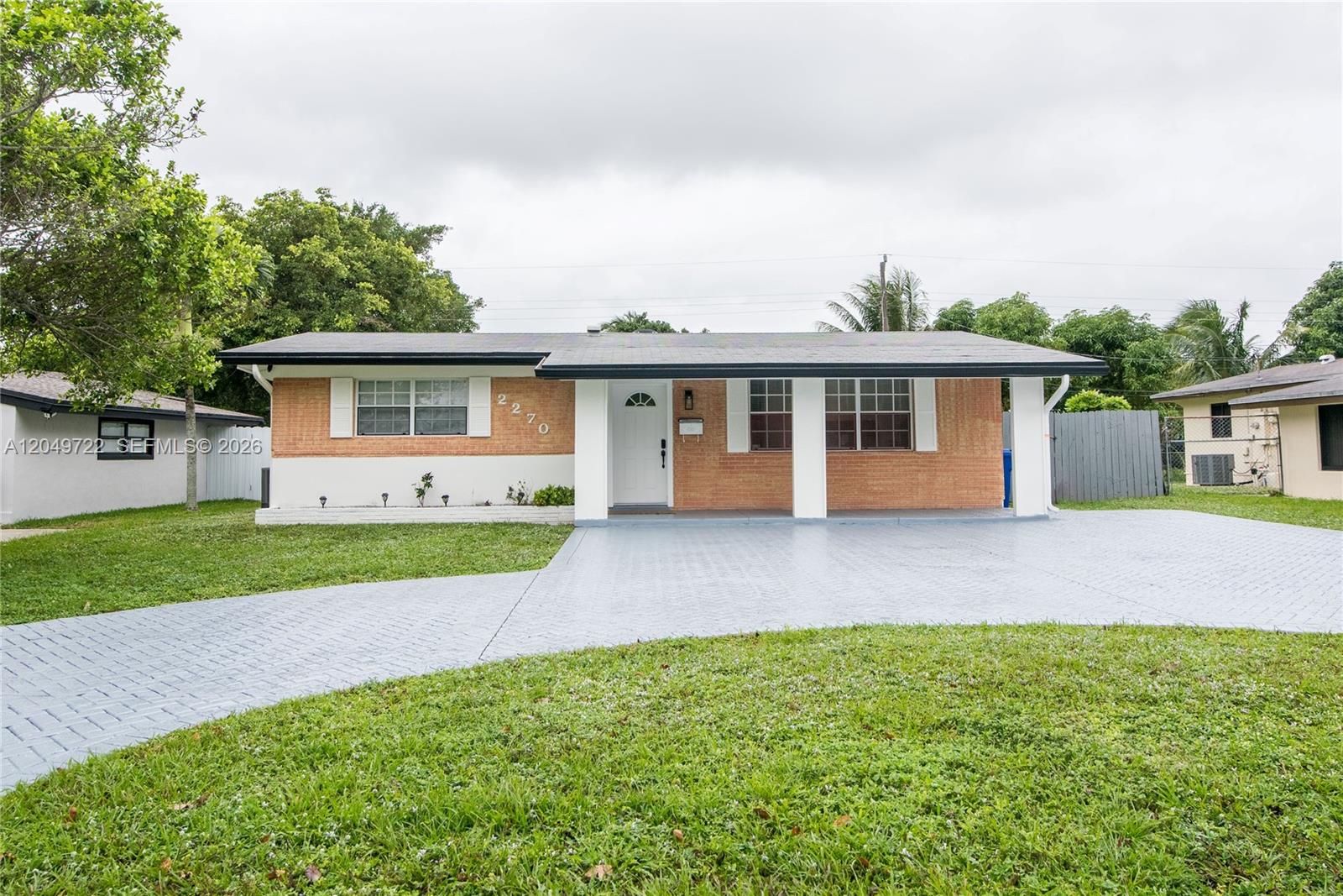 A single-story house with a brick facade, white trim, and a paved driveway — 2270 Havana Dr, Miramar FL 33023, MIRAMAR, FL