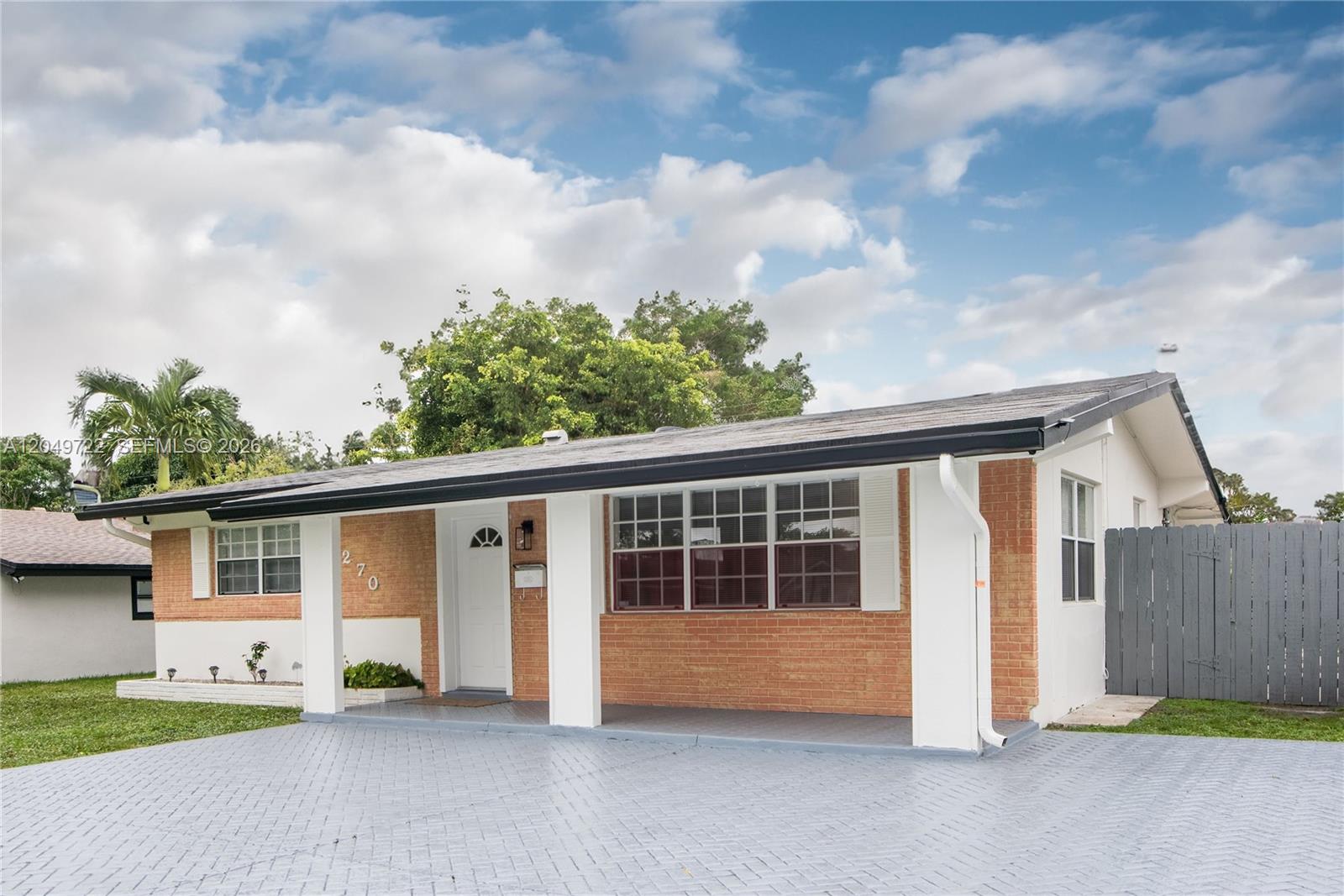 A single-story house with a brick facade, white columns, and a paved driveway — 2270 Havana Dr, Miramar FL 33023, MIRAMAR, FL