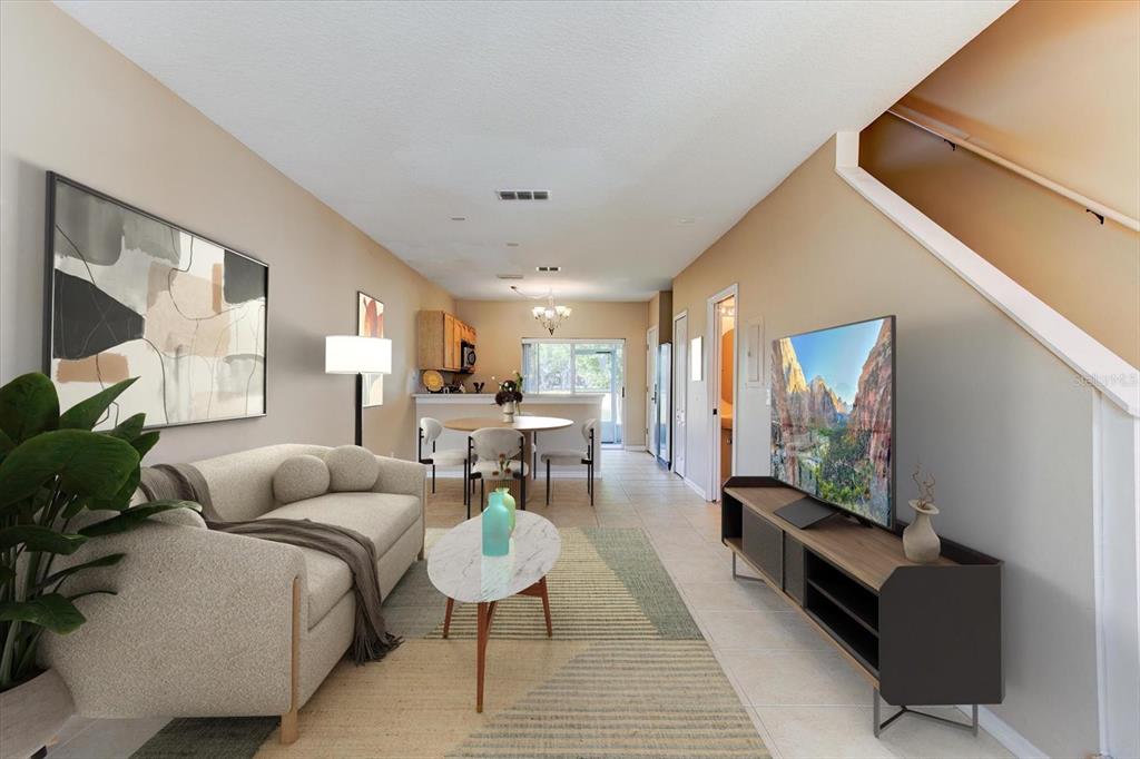 A living room and dining area with tile floors, a sofa, and a television console — 509 WILTON CIRCLE, SANFORD, FL