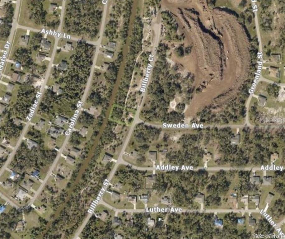 This is an aerial map view of a residential neighborhood with streets and wooded lots — BILLBERRY STREET, NORTH PORT, FL