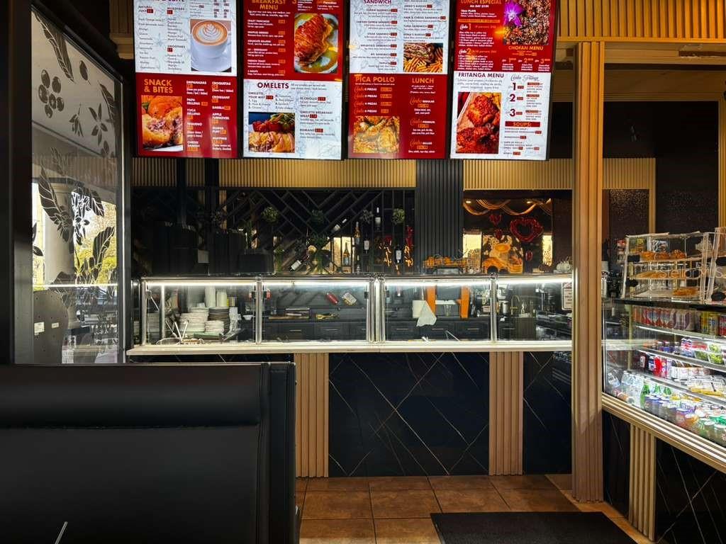 A restaurant interior features digital menu boards above a service counter with glass display cases — 730 SAND LAKE ROAD UNIT 30, ORLANDO, FL