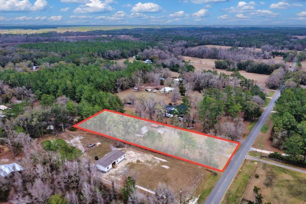 An aerial view shows a rectangular property outlined in red containing trees and buildings — 4912 NE HIGHWAY 349, OLD TOWN, FL