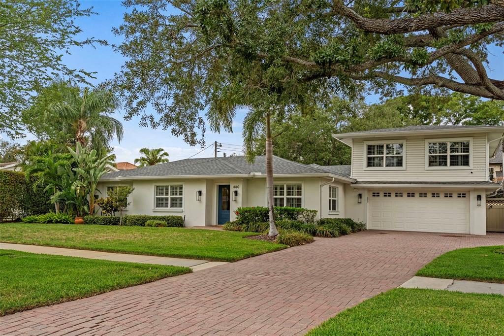 A single-story house with a white exterior, a brick driveway, and a two-car garage — 480 W DAVIS BOULEVARD, TAMPA, FL