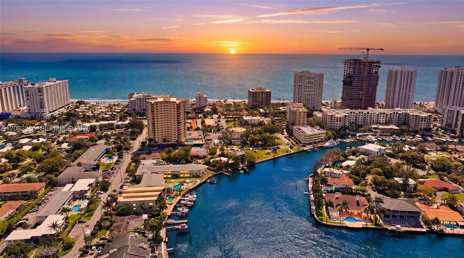 An aerial view of a coastal city with high-rise buildings, a canal, and a sunset — 3216 SE 12th St # 8, Pompano Beach FL 33062, POMPANO BEACH, FL