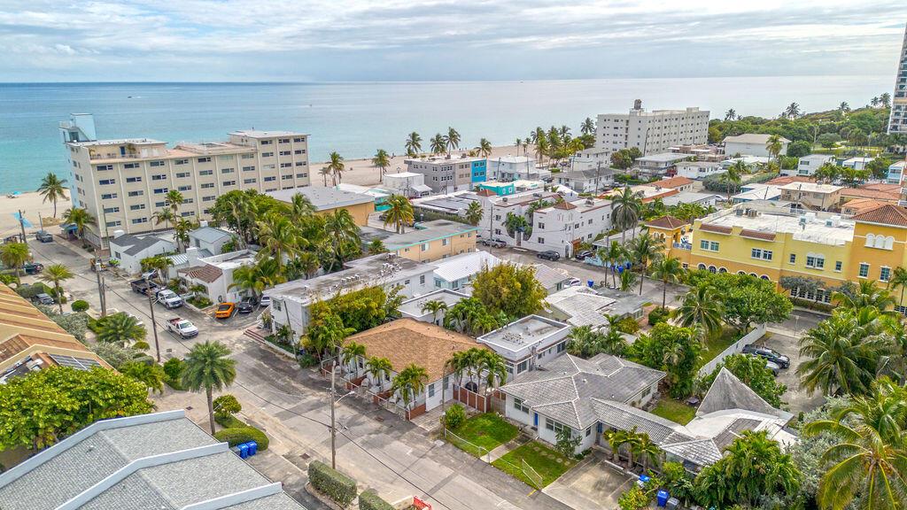 An aerial view of a coastal neighborhood with houses, apartment buildings, and the ocean beyond — 334 Oregon Street, Hollywood FL 33019, HOLLYWOOD, FL
