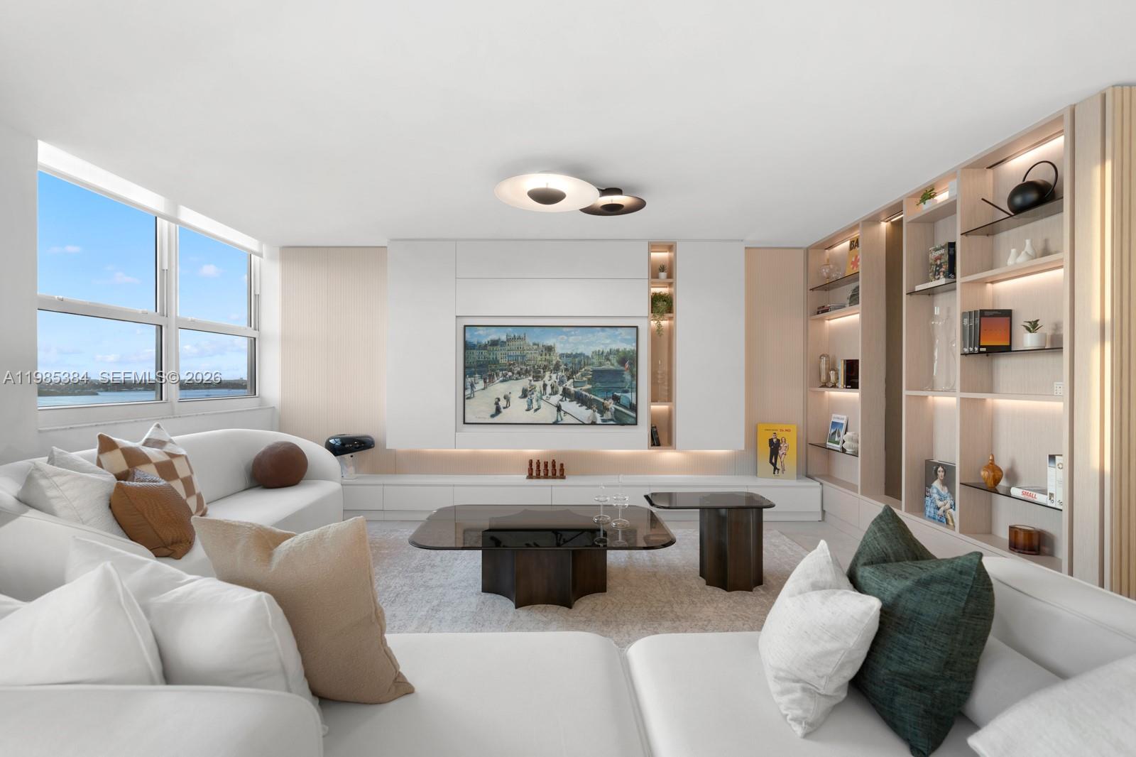 A modern living room features a white media wall, built-in shelving, and a large sectional sofa — 650 West Ave, Miami Beach FL 33139, MIAMI BEACH, FL