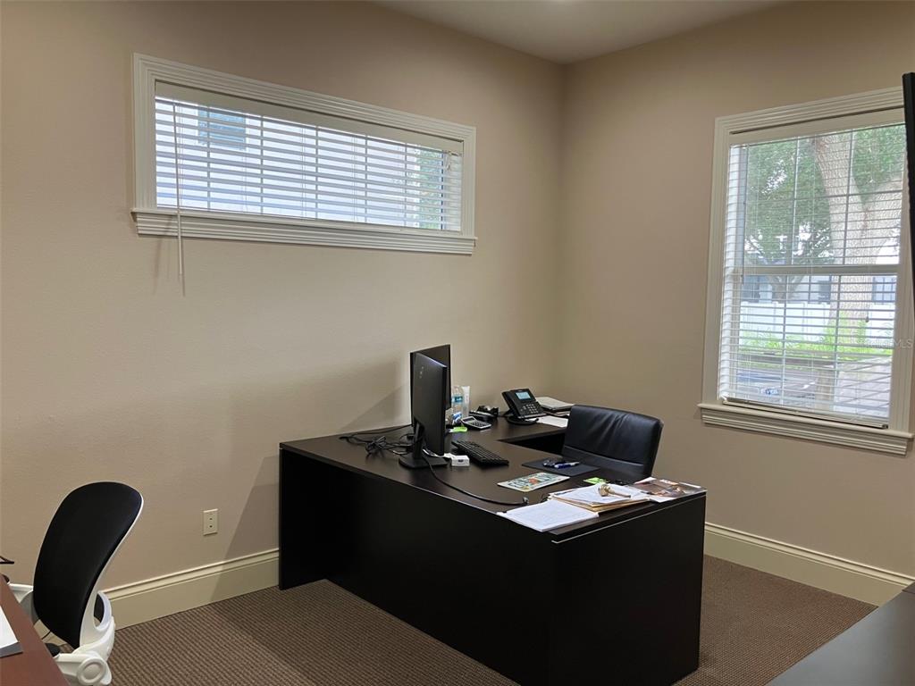 An office with a dark desk, two chairs, and windows with white blinds — 5813 and 5815 S MACDILL AVENUE, TAMPA, FL