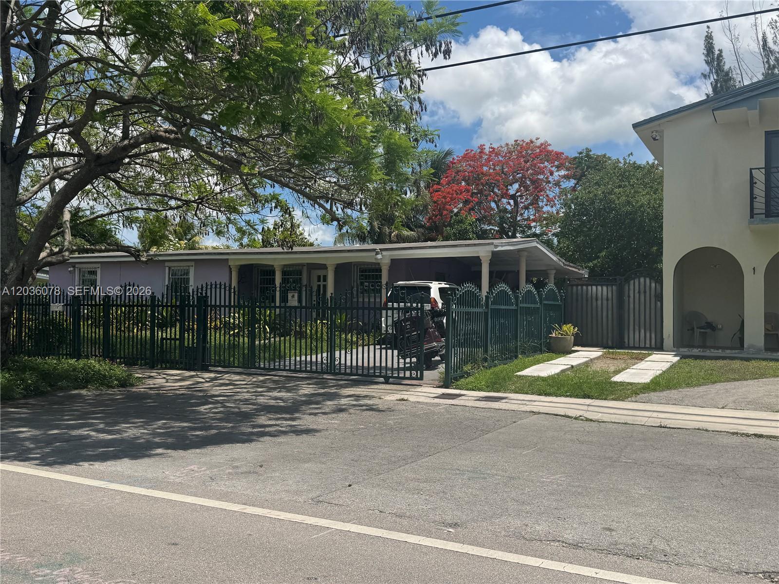 A single-story house with a purple exterior, a carport, and a black metal fence — 11290 SW 47th Ter, Miami FL 33165, MIAMI, FL