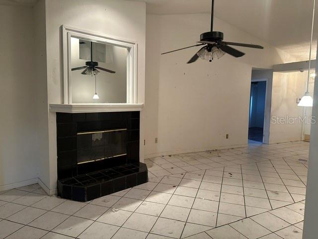 A room with white tiled floors, a black fireplace, and a ceiling fan — 4729 S DAWNMEADOW COURT, PLANT CITY, FL