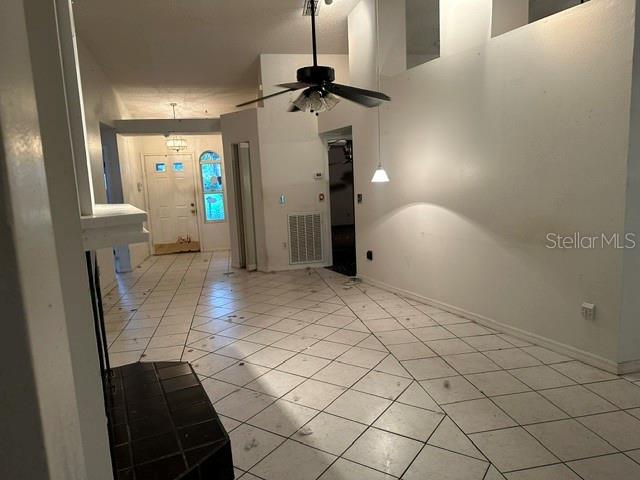 An interior view shows a living area with white tiled floors, a ceiling fan, and a doorway — 4729 S DAWNMEADOW COURT, PLANT CITY, FL