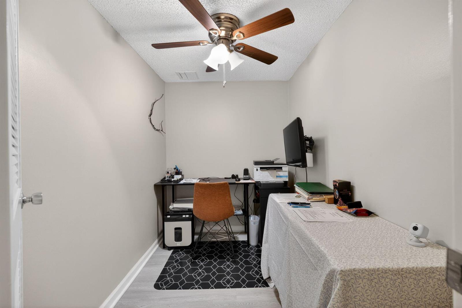 A small home office features a desk, a chair, a table, and a ceiling fan — 1200 Marine Way, North Palm Beach FL 33408, NORTH PALM BEACH, FL