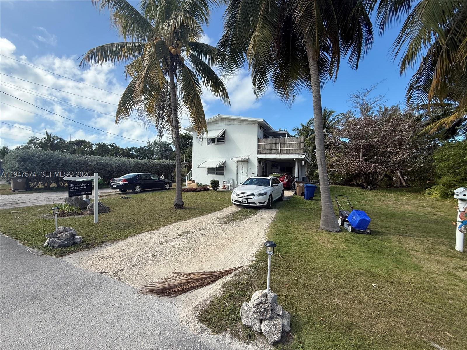 A two-story white house with a palm tree in the front yard and two cars — 329 63rd Court Gulf, Marathon FL 33050, MARATHON, FL