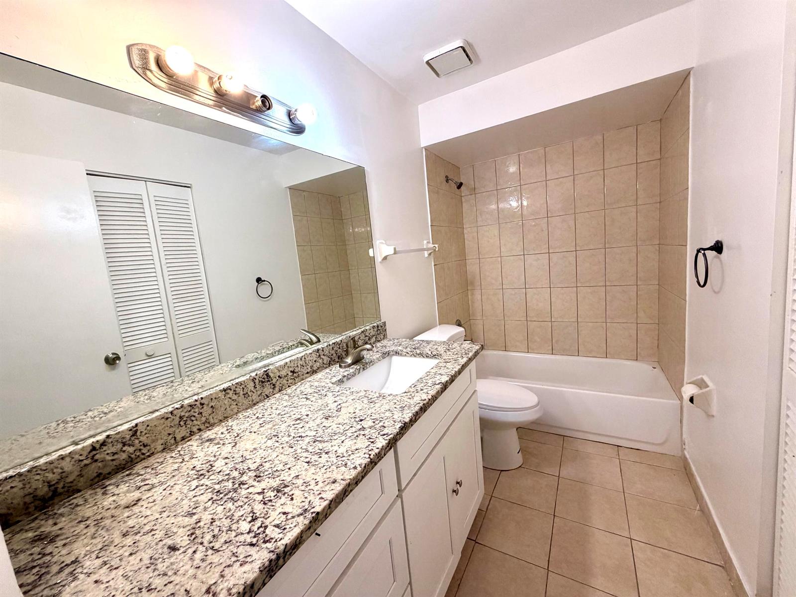 A single-story house with a concrete driveway, brown trim, and a small front garden — 3768 Mil Lake Court, FL 33463, FL
