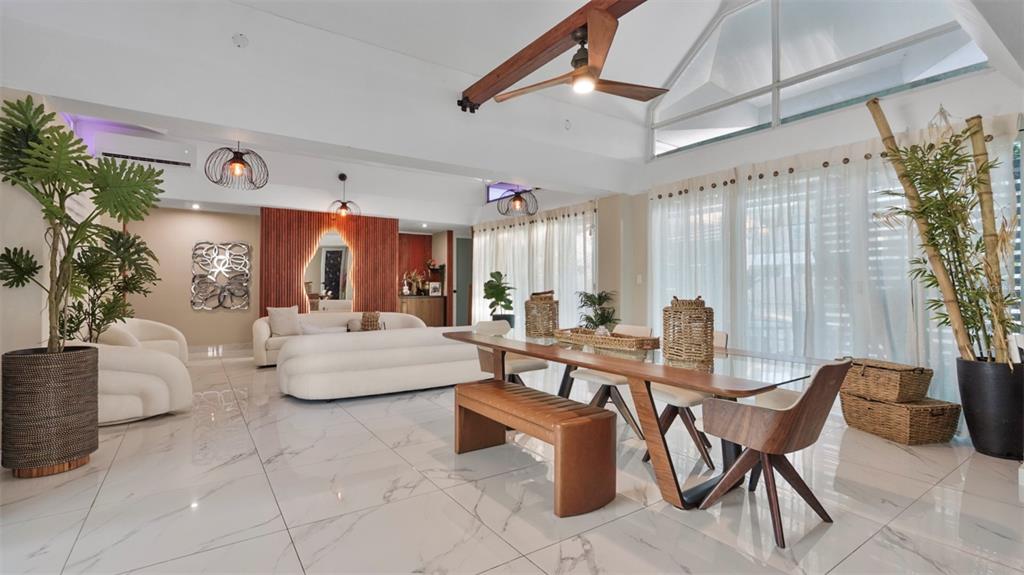 A bright, open-concept living and dining area features white marble floors and vaulted ceilings — G-6 LOMBARDIA STREET, NAGUABO, PR